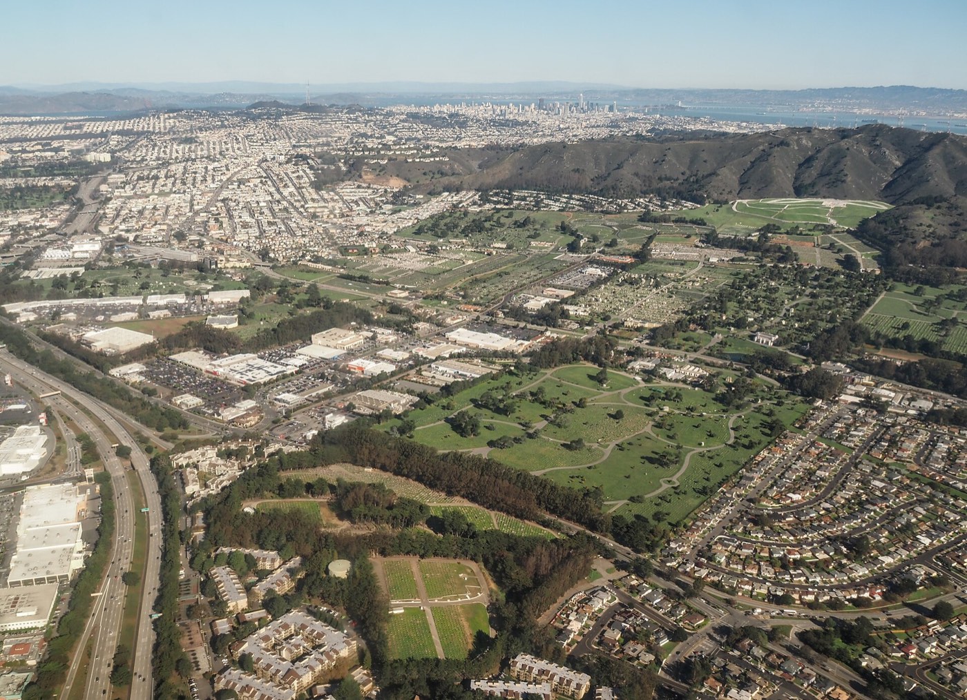 Aerial view across Colma toward San Bruno Mountain and San Francisco